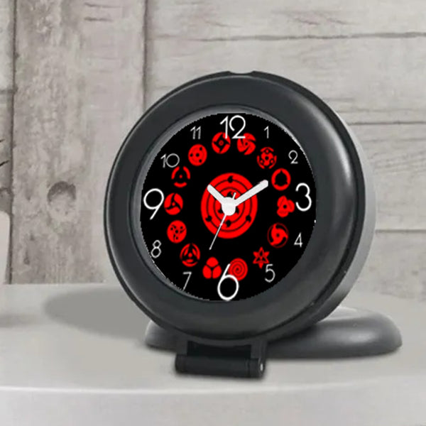 a black and red clock on a white wall 