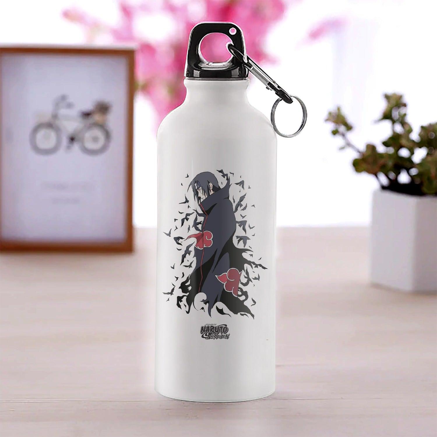 a bottle of water sitting next to a white vase 